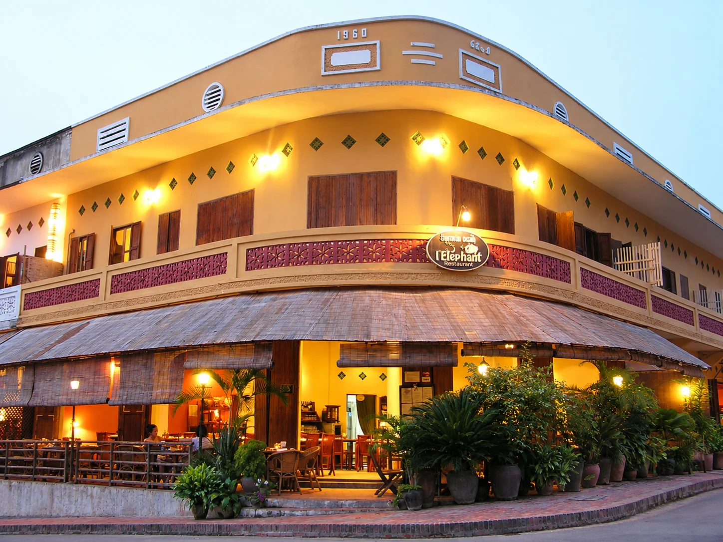 The façade of L’Éléphant at twilight in Luang Prabang